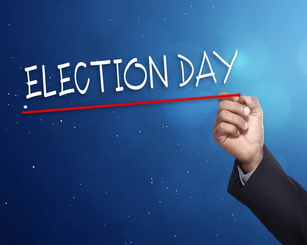 Hand with election day sign on chalkboard — Stock Photo, Image
