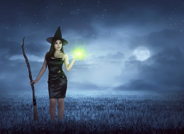 Asian witch with broom and magic spell — Stock Photo, Image