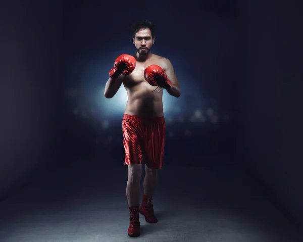 Portrait of asian male boxer with red gloves
