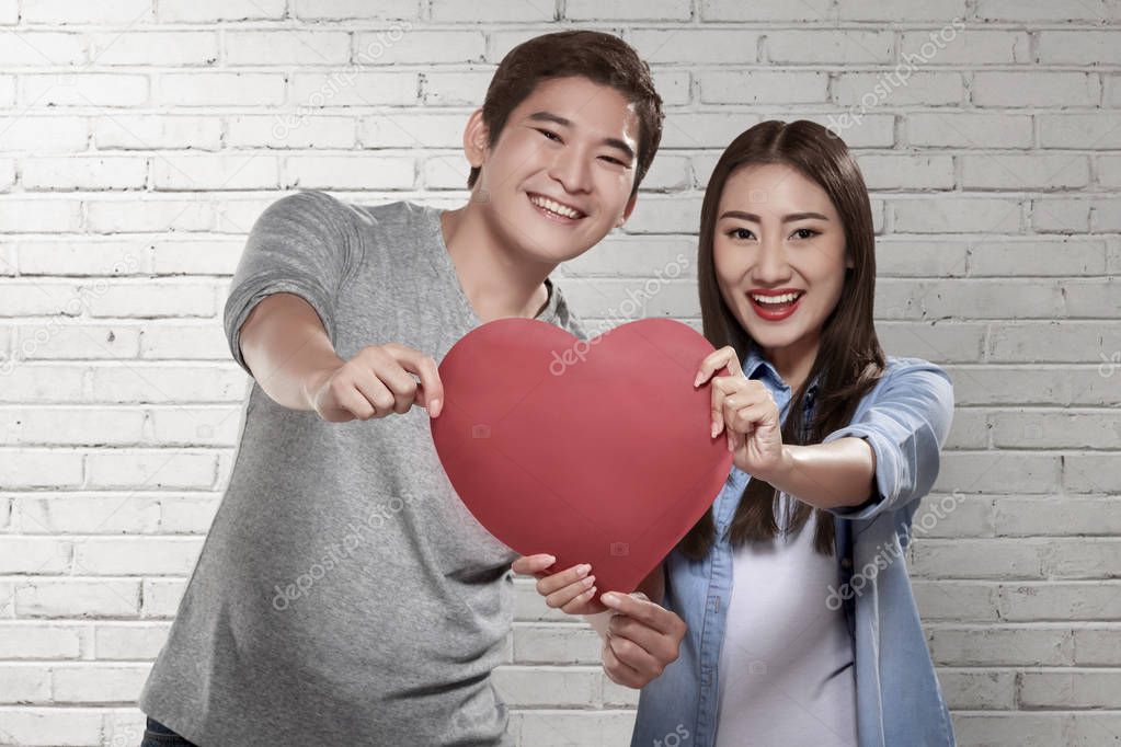 asian couple holding red heart