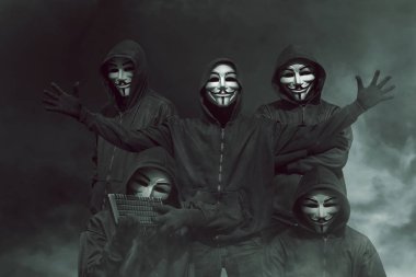 hackers in masks with keyboard