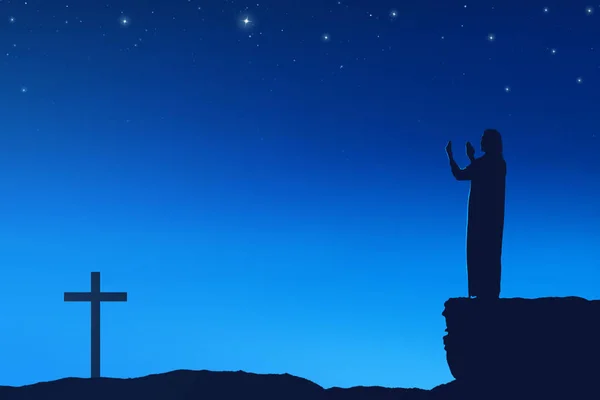 Silhouette of man praying to god with cross shape