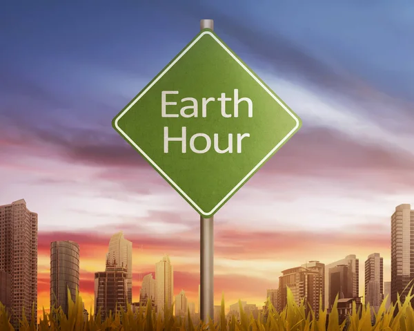 Час Земли приветствие на дорожном знаке на закате — стоковое фото