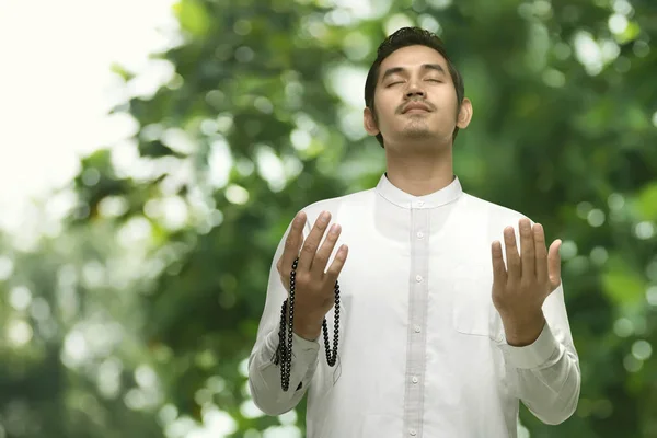 Muslim man praying with prayer beads — Stock Photo, Image