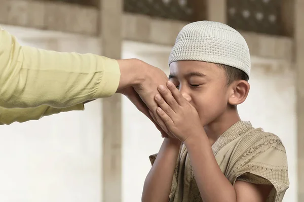 muslim child kissing hand