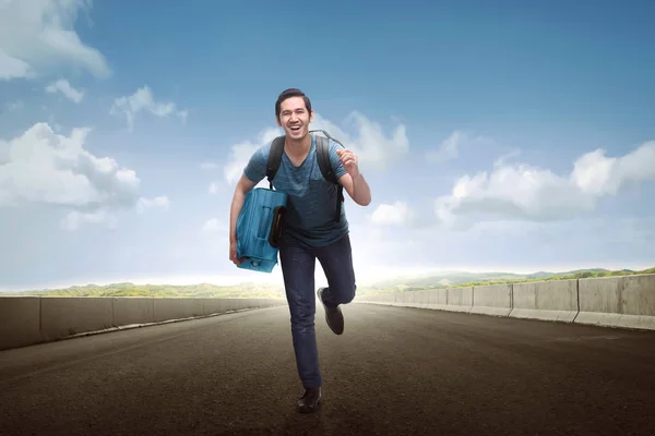 Feliz asiático turista hombre llevar equipaje corriendo — Foto de Stock