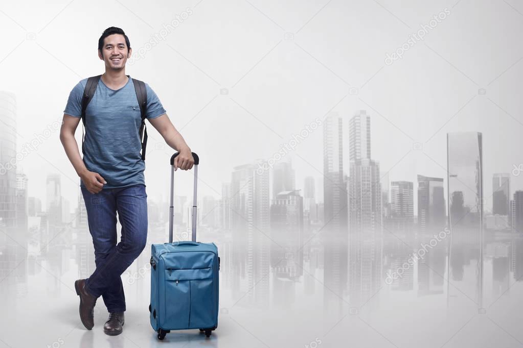 tourist man with suitcases standing