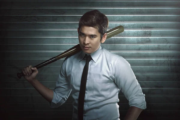 Young asian man with wooden baseball bat standing — Stock Photo, Image