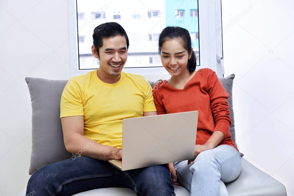 Asian couple using laptop