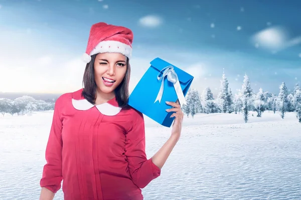 Beautiful asian woman with santa hat holding xmas gift — Stock Photo, Image