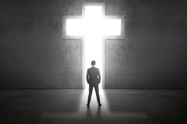 Business man standing in front of the shining cross — Stock Photo, Image