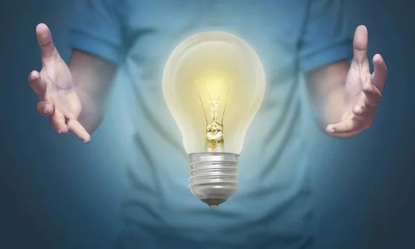 Man Holding Bright Lights Bulb — Stock Photo, Image