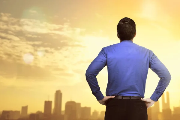 businessman looking at sunset view