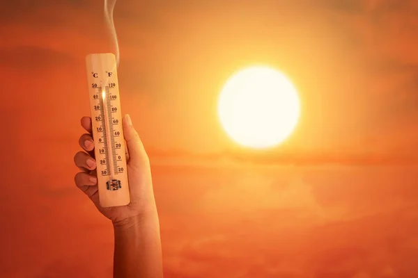Mão segurando o termômetro com alta temperatura no ar wi — Fotografia de Stock
