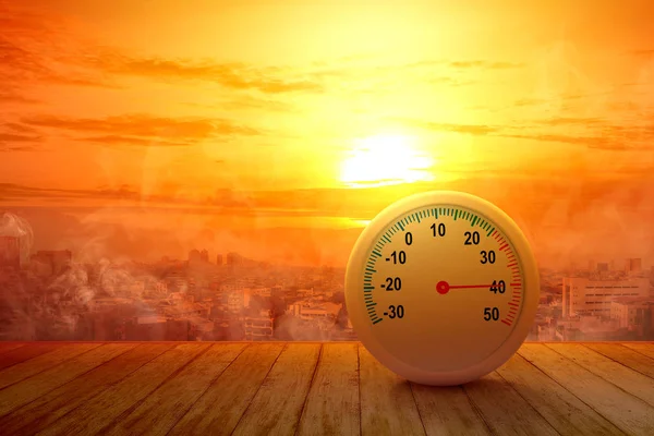The thermometer on a wooden table with a high temperature on the — Stock Photo, Image