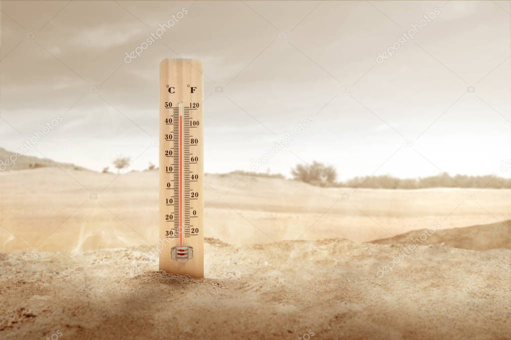 Thermometer with high temperature on the desert with sunlight ba