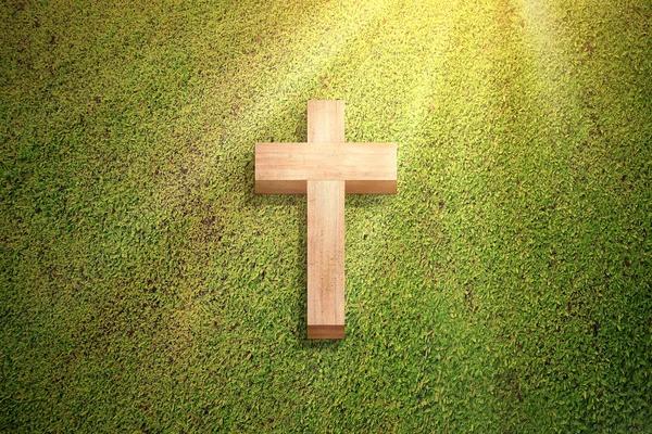 Христианский крест на зеленой траве — стоковое фото