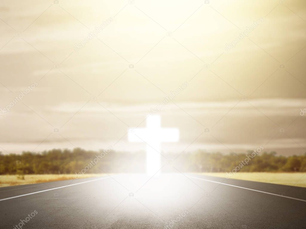 Christian cross at the end of the road