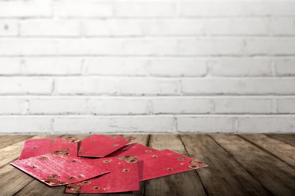 Stack of Red envelopes on wooden tables to celebrate Chinese New — Stock Photo, Image