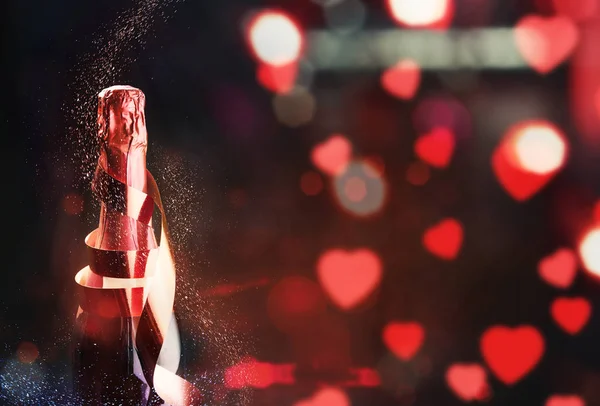 The champagne bottle with ribbon and colorful glitter for celebr — 스톡 사진