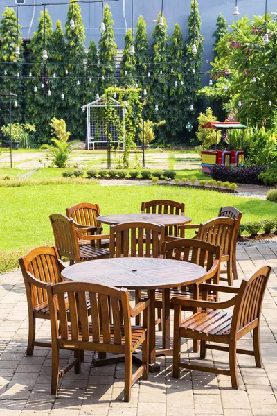 Wooden round table with chairs in the park
