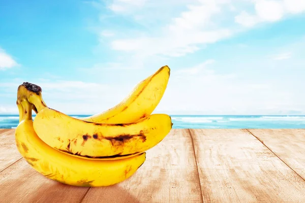 Banana on the table with ocean view background