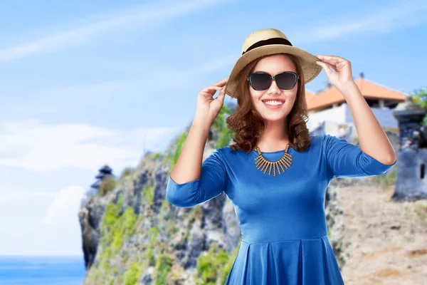 帽子とサングラスを持つアジアの女性は青い空の背景を持つビーチに旅行 — ストック写真
