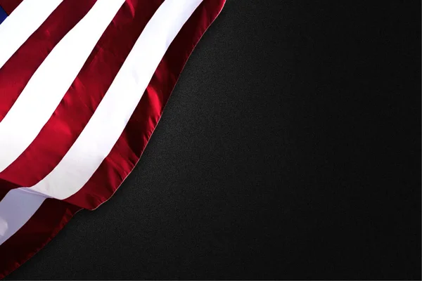 American flag folded on a black background. Fourth of July Concept