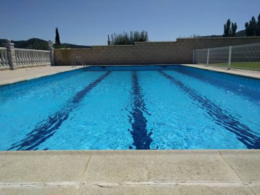 Piscina particular de pueblo. Particular swimming pool. clipart