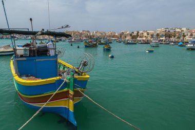 Colourful painted fishing boats in the harbour of Marsaxlokk, Malta