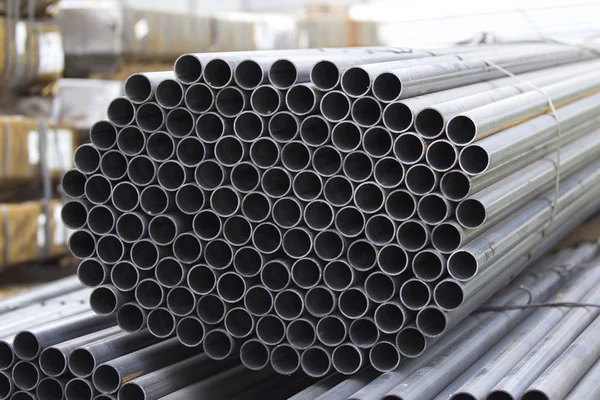 Metal profile pipe of round section in packs at the warehouse of metal products — Stock Photo, Image