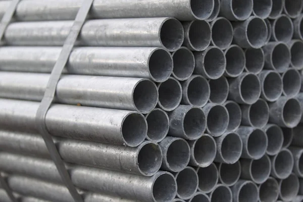 Metal profile pipe of round section in packs at the warehouse of metal products — Stock Photo, Image