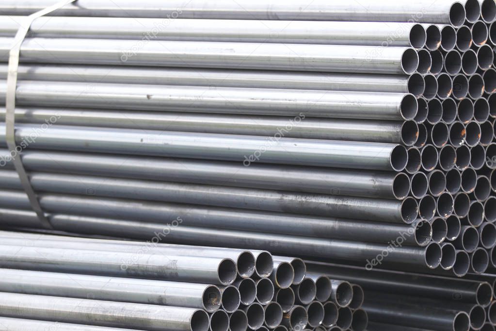 Metal profile pipe of round section in packs at the warehouse of metal products, Russia