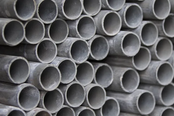 Metal profile pipe of round section in packs at the warehouse of metal products