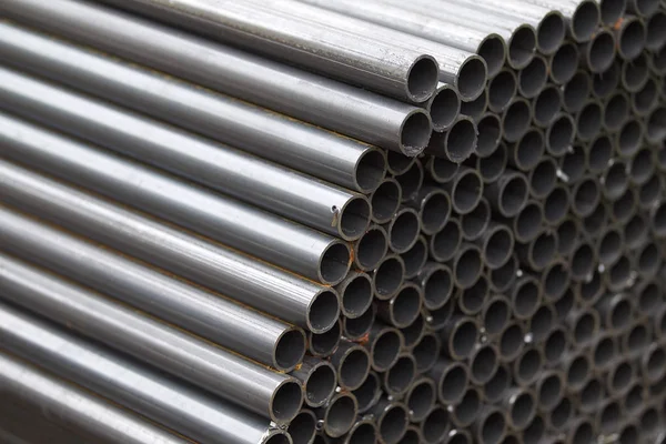 Metal profile pipe of round section in packs at the warehouse of metal products — Stock Photo, Image