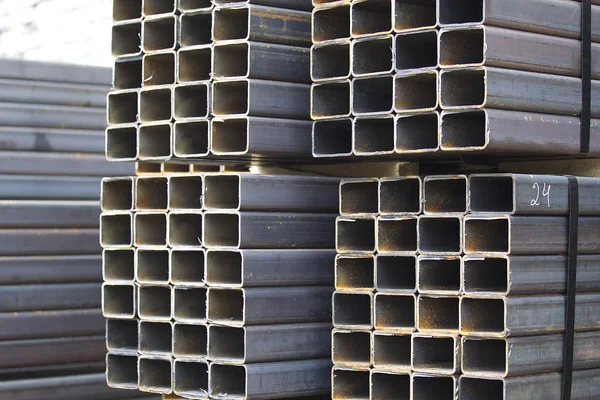 Metal profile pipe of rectangular cross section in packs at the warehouse of metal products — Stock Photo, Image