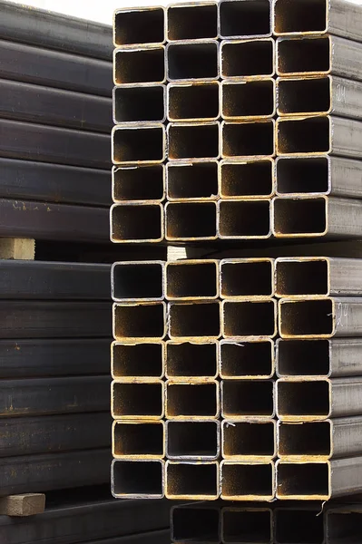 Metal profile pipe of rectangular cross section in packs at the warehouse of metal products — Stock Photo, Image