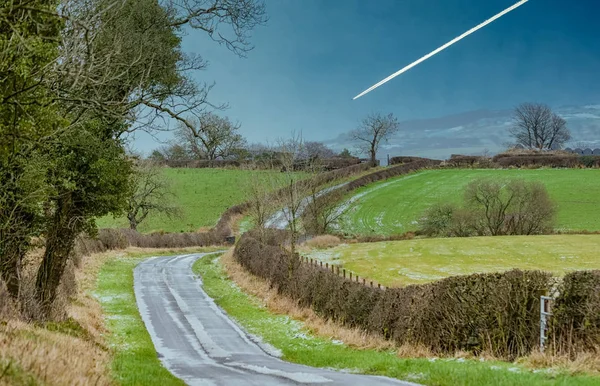 Icy Road Lightly Covered Snowing Hills Far Hazy Distance Jet — Stock Photo, Image