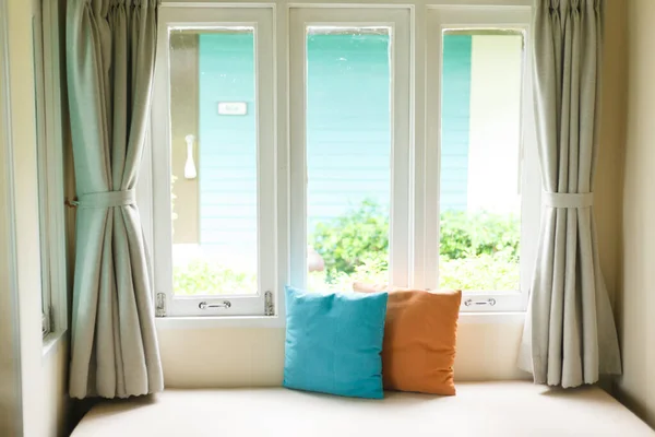 Living room corner with sofa bed at the white window.