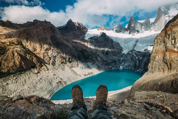 추적 산과 흐린 하늘 가운데 푸른 호수 배경 신발 부츠 스톡 사진