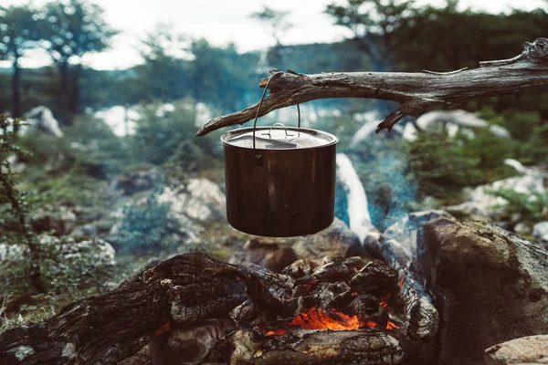 Outdoor food on fire in a camp