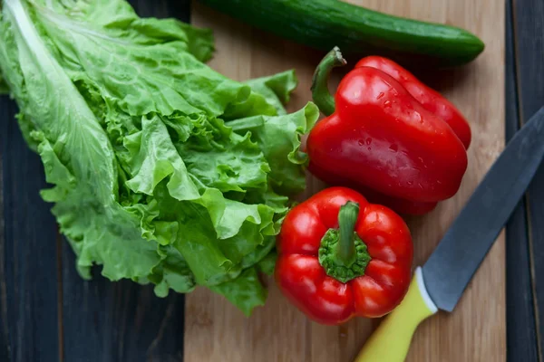 Kırmızı biber, salatalık ve k ile ahşap tahta üzerinde taze salata
