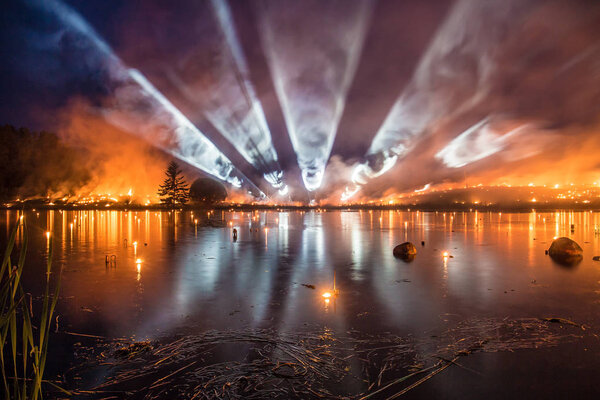 Big fire show with searchlights and lots of smoke over a beautif