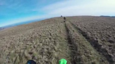 Motosikletliler dağlarda çakıllı bir yolda gezerler. Moto motorcu kayalık bir yolda motosiklet sürüyor.. 