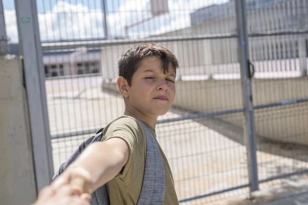 stock image Cheerful child carrying his backpack standing in front of the sc