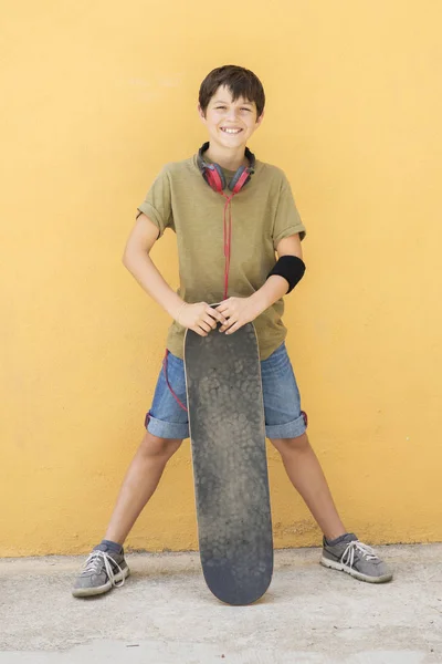 A Teen with skateboard on the city street