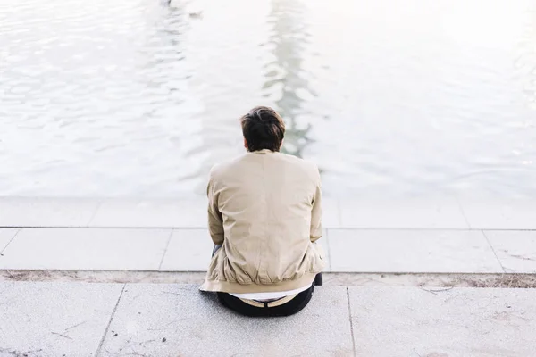 Handsome young man on a lake in a sunny, peaceful day