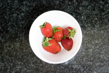 Koyu mermer üzerinde çilek manzarası