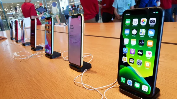 IPhone 11 are showing on the wooden table in the Apple Store Iconsiam. — Stock Photo, Image