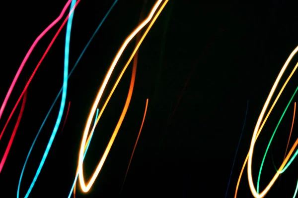 Multicolored lines fire light painting on night dark black background. Celebration holiday concept